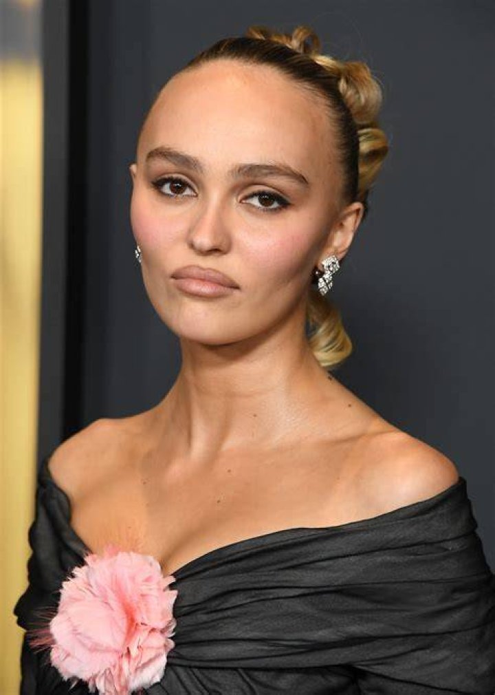 Lily Rose Depp dons skimpy denim jeans shorts over purple bodysuit on